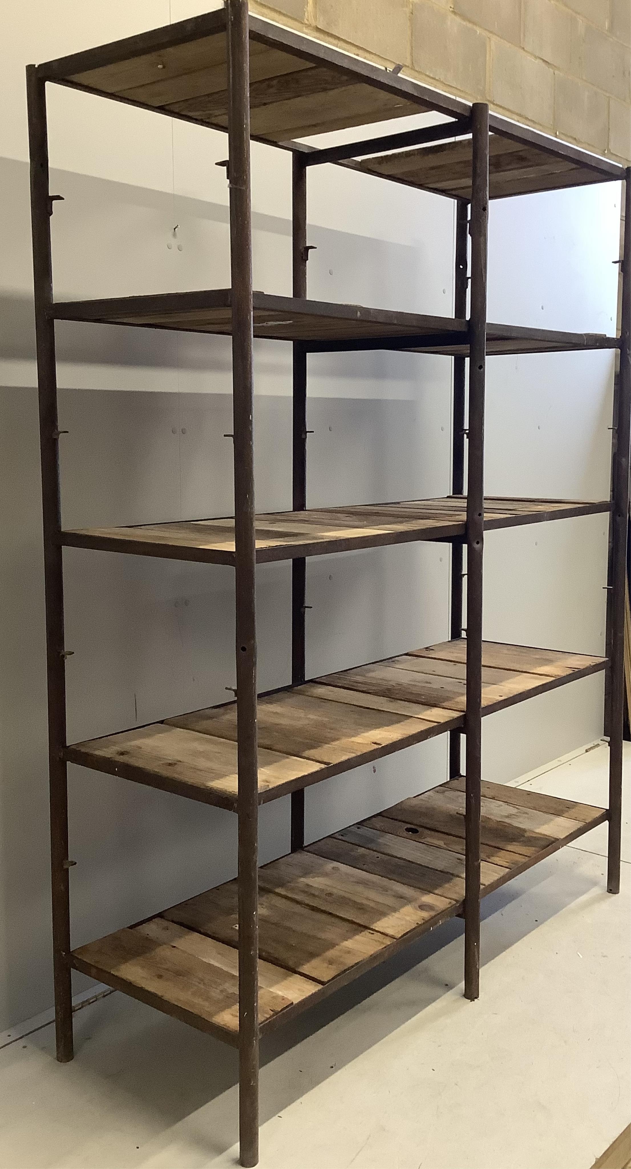 An industrial style wrought iron open shelf unit, width 154cm, depth 57cm, height 200cm. Condition - fair